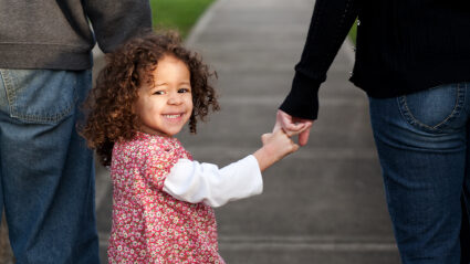 Daugther Holding Parents' Hands Istock 000008966098xsmall